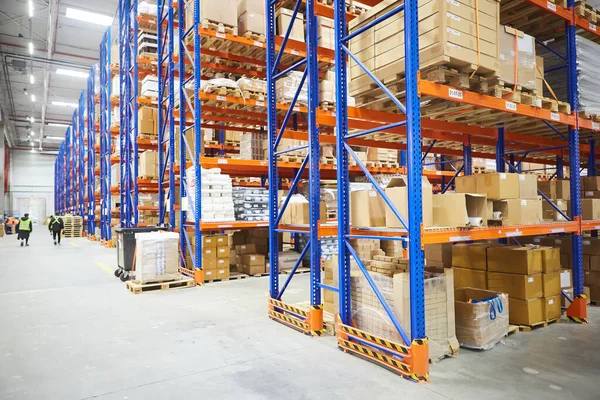 Huge distribution warehouse with high shelves and loaders.