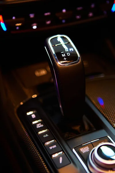 Automatic gear stick of a modern car, multimedia and navigation control buttons. Car interior details. Transmission shift. Shallow dof — Stockfoto