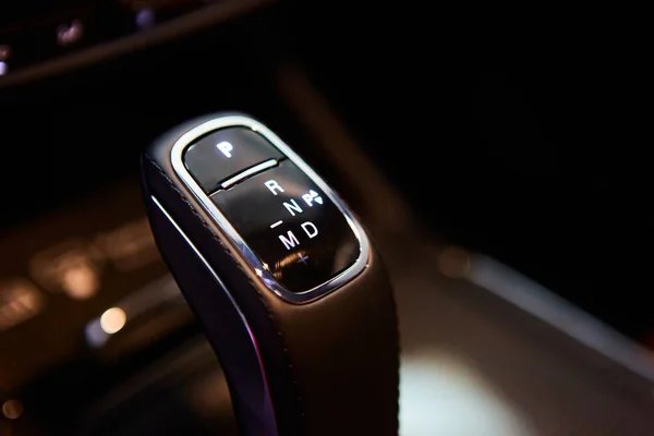 Automatic gear stick of a modern car, multimedia and navigation control buttons. Car interior details. Transmission shift. Shallow dof —  Fotos de Stock