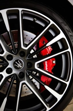 Ukraine, Kyiv - October 10, 2021: Closeup wheel with red brake discs. Presentation of new models Maserati
