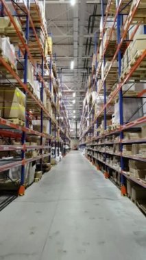 Huge distribution warehouse with high shelves and loaders.