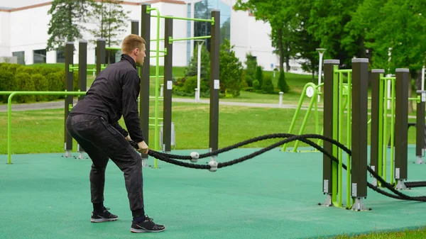 バトル ロープ バトル男性ロープ通りフィットネス ジムで運動. — ストック写真