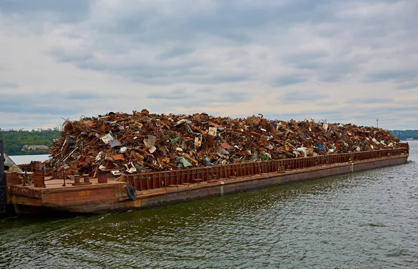 Transportation industry. Ship barge transports scrap metal and sand with gravel.