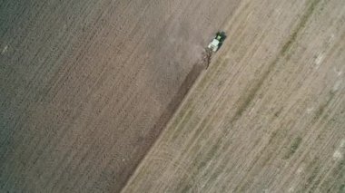Aerial view plowing the land by tractor for cultivation. Kyiv region, Ukraine.