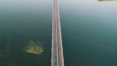 Aerial top view of bridge road automobile traffic of many cars, transportation concept. Kyiv, Ukraine.