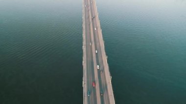 Aerial top view of bridge road automobile traffic of many cars, transportation concept. Kyiv, Ukraine.