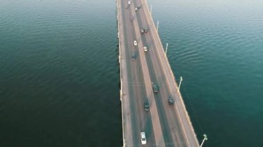 Aerial top view of bridge road automobile traffic of many cars, transportation concept. Kyiv, Ukraine.