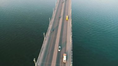 Aerial top view of bridge road automobile traffic of many cars, transportation concept. Kyiv, Ukraine.
