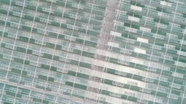 Glass greenhouses from above in sunny weather.