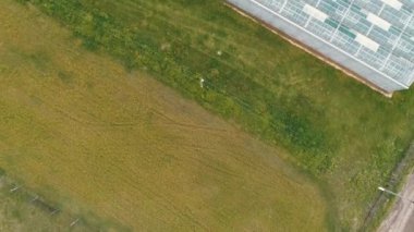 Glass greenhouses from above in sunny weather