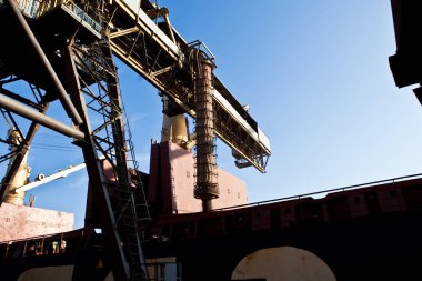 Loading grain into holds of sea cargo vessel in seaport from silos of grain storage. Bunkering of dry cargo ship with grain.