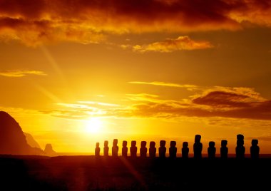 Mysterious stone statues at sunrise in Easter Island clipart