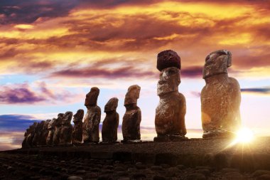 Standing moais in Easter Island at sunrise clipart