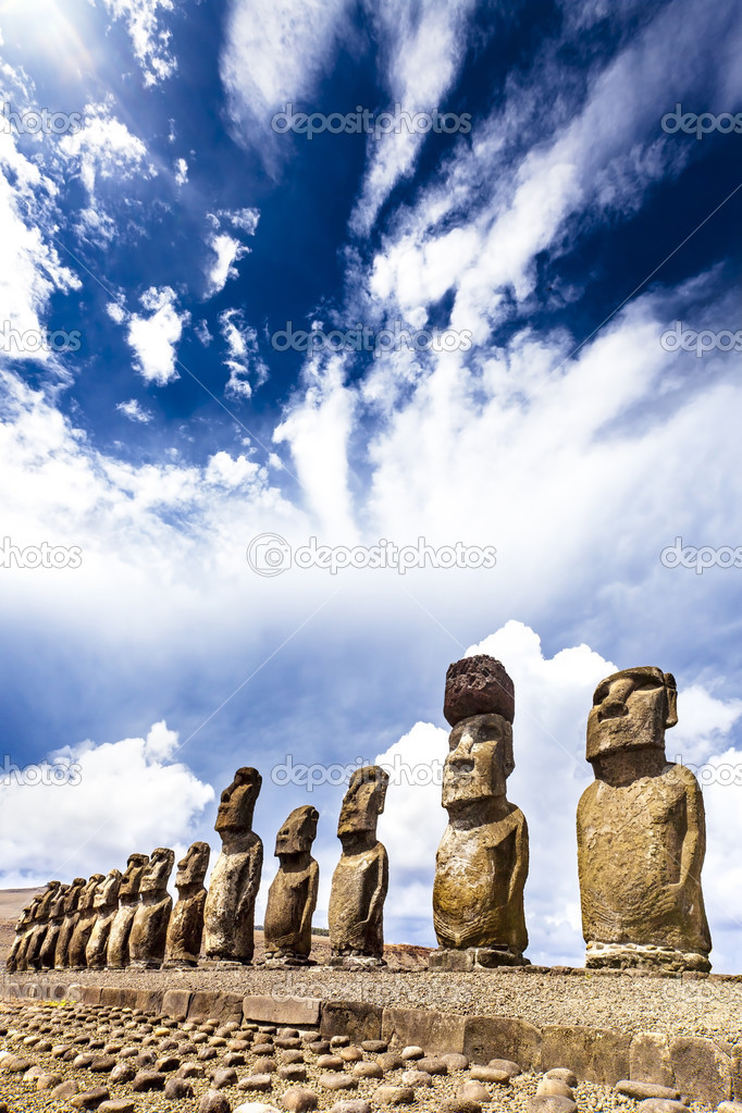 Moais standing on ahu with dramatic clouds in background in Easter Island