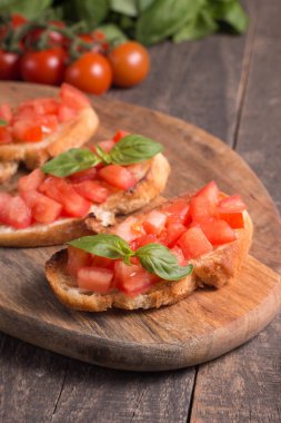 Domates ve fesleğen taze bruschetta. İtalyan mezesi, sebzeli pandispanya ızgara ciabatta ve baget ekmekli yağ. Sandviç..