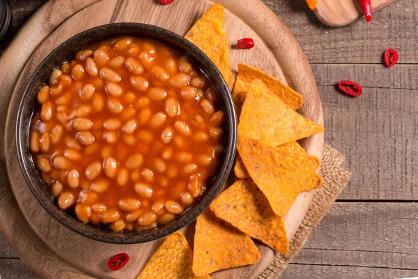 Chili beans on wooden table background. Kidney beans and vegetable Mexican food.