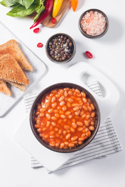 Chili beans on wooden table background. Kidney beans and vegetable Mexican food.