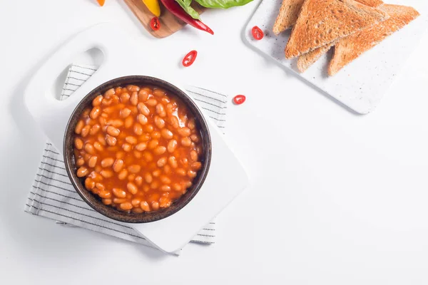 Chili beans on wooden table background. Kidney beans and vegetable Mexican food.