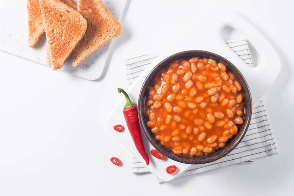 Chili beans on wooden table background. Kidney beans and vegetable Mexican food.