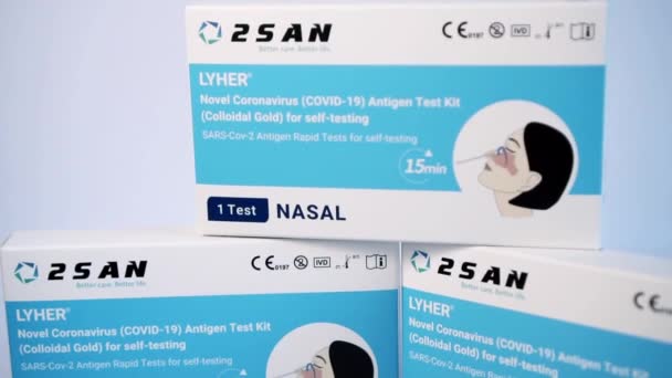 Tre COVID-19 Rapid Antigen Test kit på displayen, vit bakgrund — Stockvideo