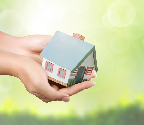 Holding house representing home ownership — Stock Photo, Image