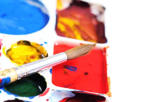 Artists palette with various colour paints and brush — Stock Photo, Image