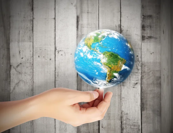 Earth in human hand against — Stock Photo, Image