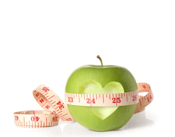 Green apples measured the meter on white — Stock Photo, Image