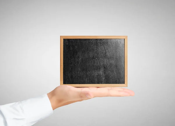 Businessman holding  blank blackboard — Stock Photo, Image