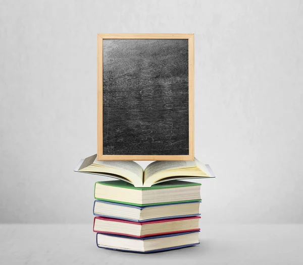 Blackboard on book  with wooden frame — Stock Photo, Image