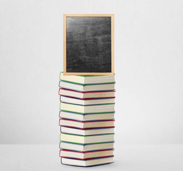 Quadro negro no livro com moldura de madeira — Fotografia de Stock