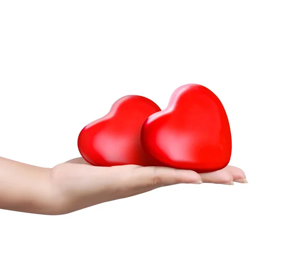 Czerwone serce pod ręką kobiety — Zdjęcie stockowe
