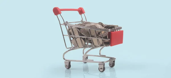 コインと消費者社会のトレンドとおもちゃのショッピングカート — ストック写真