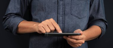 Man holding smartphone device  holding smartphone device and touching screen