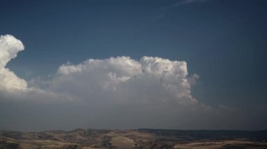 8K 7680X4320 4320p.Fading clearing cumulus clouds on steppe hills.A normal day in standard steppe terrain.Barren scrub, sparsely wooded steppe hills.Ambience partly cloudy ambiance scene scenic cinematic time lapse sparse background landscape