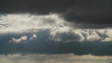 8K 7680x4320.Approaching storm clouds in variable weather.Thick dark stratonimbus clouds covered the sky.Gray storm cloud in forecast.Windy storms are coming.Nimbostratus grey meteorology time lapse.