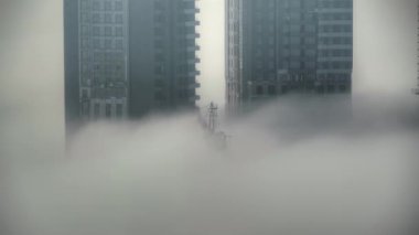 Cinematic 8K 7680x4320.Skyscraper construction above the clouds.Skyscrapers on the cloud and fog.Fogs foggy convection urban building moist misty moisture damp apartment site city high tower cloud view time lapse nature soft wonderful sea of fog 8K.