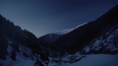 8K 7680X4320 4320p.Day to night transition time effect at snowy mountain forest in winter morning.Mountain cold cloudless weather mount sunrise sunup snow at dawn twilight early morning day before after time unspoiled mountainous higher terrain
