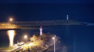 8K 7680X4320 4320p.Lights of lighthouses in the night fishing port at sea.A lighthouse is a tower, building, or other type of structure designed to emit light from a system of lamps and lenses.Harbor.