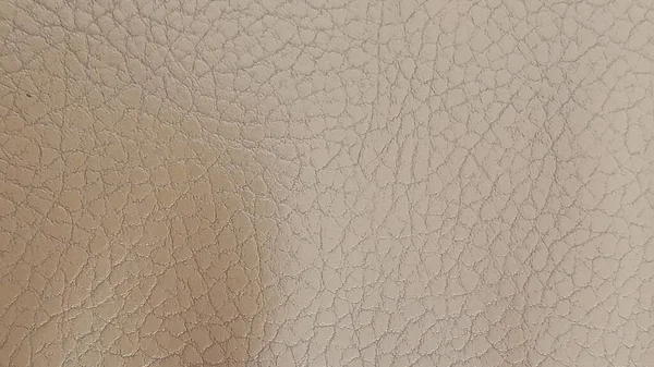 Fényes bézs bőr háttér közelről. Bézs fényes textúra mesterséges bőrből. — Stock Fotó