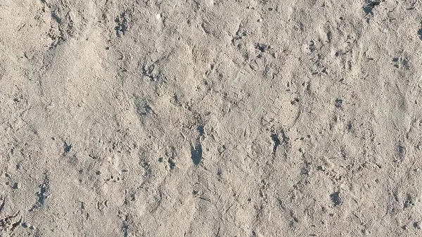 Het zand van de gedroogde rivierbodem. Een wazig beeld van een zandpatroon. — Stockfoto
