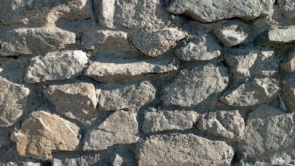 Część kamiennej ściany, do tła lub tekstury. Tekstura kamiennej ściany. Kamienna ściana jako tło lub faktura. — Zdjęcie stockowe
