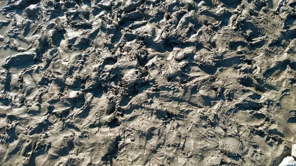 Footprint or imprint shoe in the mud.Mud texture or wet brown soil as natural organic clay and geological sediment mixture as in roughing it in a dirty muddy country ground after the rain or rainy — Stock Photo, Image