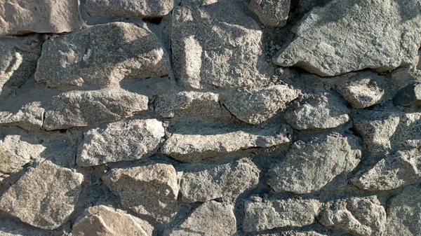 Parte de un muro de piedra, para fondo o textura. Textura de un muro de piedra. Pared de piedra como fondo o textura. — Foto de Stock