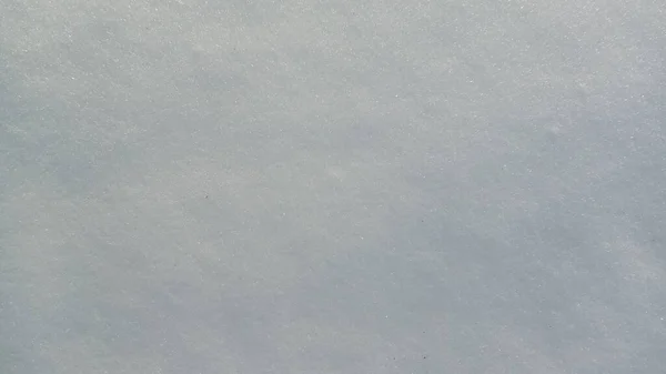 Belle texture lumineuse ensoleillée de neige en saison hivernale. Fond avec texture naturelle de neige, vue rapprochée d'en haut. — Photo