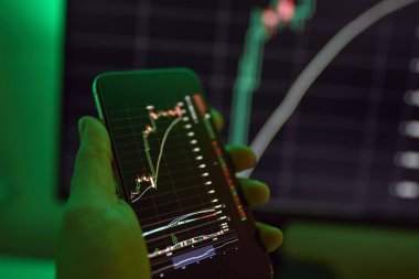 Şifreli şifreli telefon, şifreli para birimi mobil uygulaması. Bir adam bitcoin 'in fiyat tablosunu mobil uygulama kullanarak analiz eder. Kripto para ticareti konsepti..