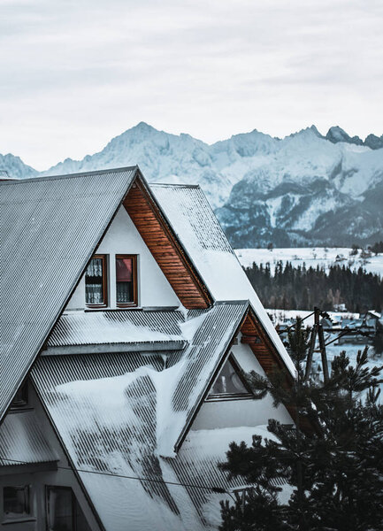 Tourists house in the mountain valley in winter. Concept of Winter holidays in the mountains. Regional Style Wooden Cottage In Winter Zakopane Poland