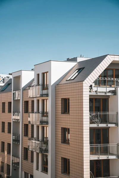 Exterior of a modern condominium. Residential area with ecological and sustainable green residential buildings, low-energy houses with apartments and green courtyard