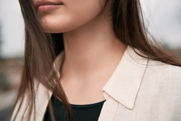 Gorgeous brunette girl wearing a light linen shirt over a black t-shirt. Cloth line advertising mock-up. No logo streetwear