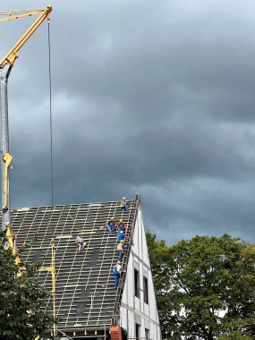 27.06.2022 Gdansk, Poland. Workers are setting up roof on a new house during construction.
